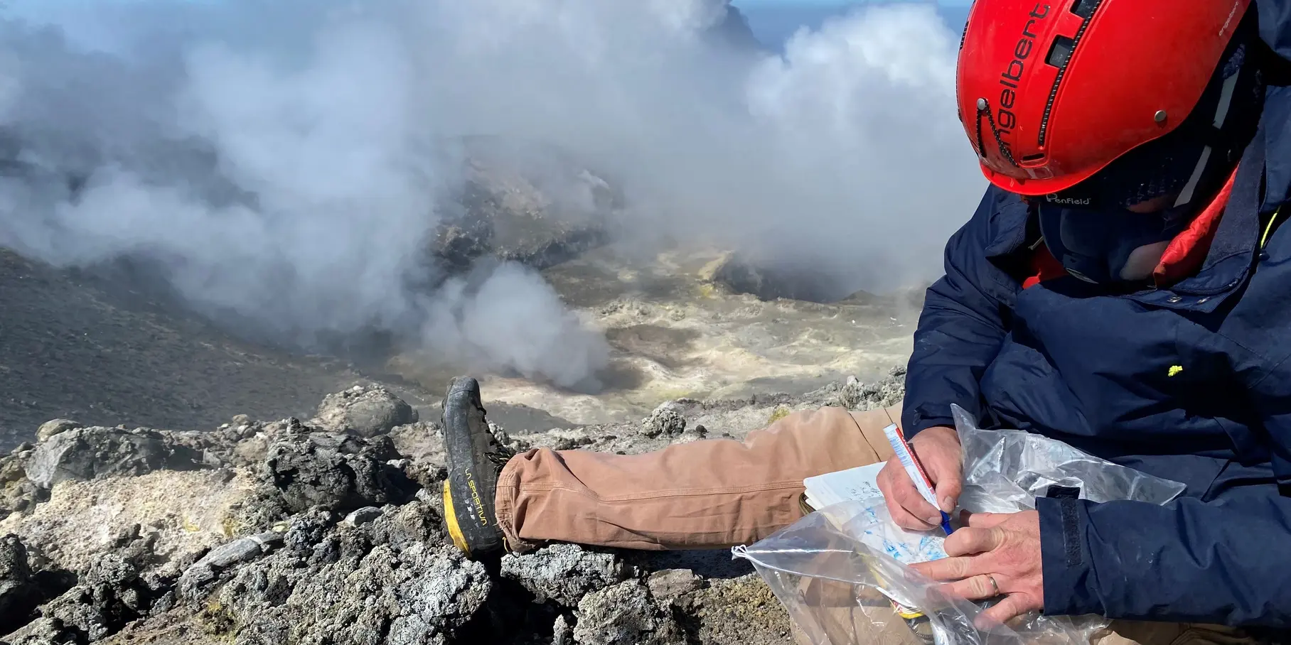 Fig 4. Rock samples collected at the summit of Mt. Etna, 2023. Here, Ben de Jarnatt collects samples of hydrothermally altered rocks for further physical and chemical analysis. (GFZ)